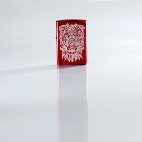 Lifestyle image of Lion Tattoo Design Candy Apple Red Windproof Lighter standing on a reflective surface