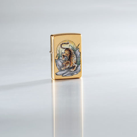Lifestyle image of Tiger Tattoo Design Brushed Brass Windproof Lighter standing on a reflective surface