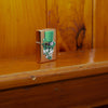Lifestyle image of Irish Skull Design Gold Dust Windproof Lighter standing on a wooden banister