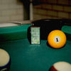 Lifestyle image of Slim Horseshoe Design Windproof Lighter standing on pool table