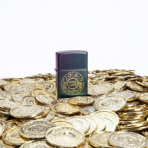Lifestyle image of Lucky Symbols Design Iridescent Windproof Lighter standing on a bed of golden coins.