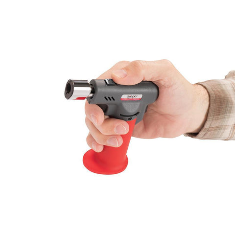 FireFast™ Torch in hand, showing the switch that allows you to switch between a soft yellow or blue flame torch