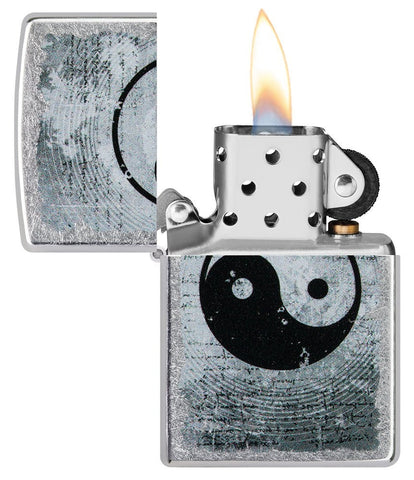 Yin Yang Design Street Chrome™ Windproof Lighter with its lid open and lit.