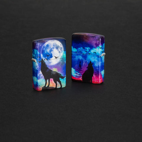 Lifestyle image of two Wolf Howling Design 540 Color Windproof Lighters standing in a grey surface. One lighter is showing the front of the design, and the other lighter is showing the back.