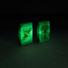 Glamour Shot of two Zippo Compass Ghost Design 540 Glow in the Dark Windproof Lighters glowing in the dark.