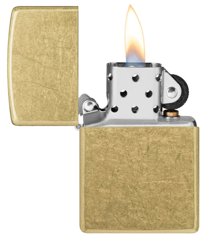 Zippo Street Brass Classic Windproof Lighter with its lid open and lit.