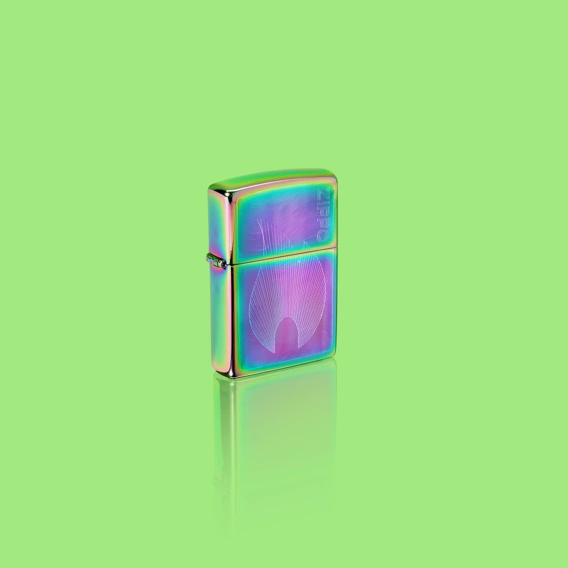 Glamour shot of Zippo Dimensional Flame Design Multi Color Windproof Lighter standing in a green scene.