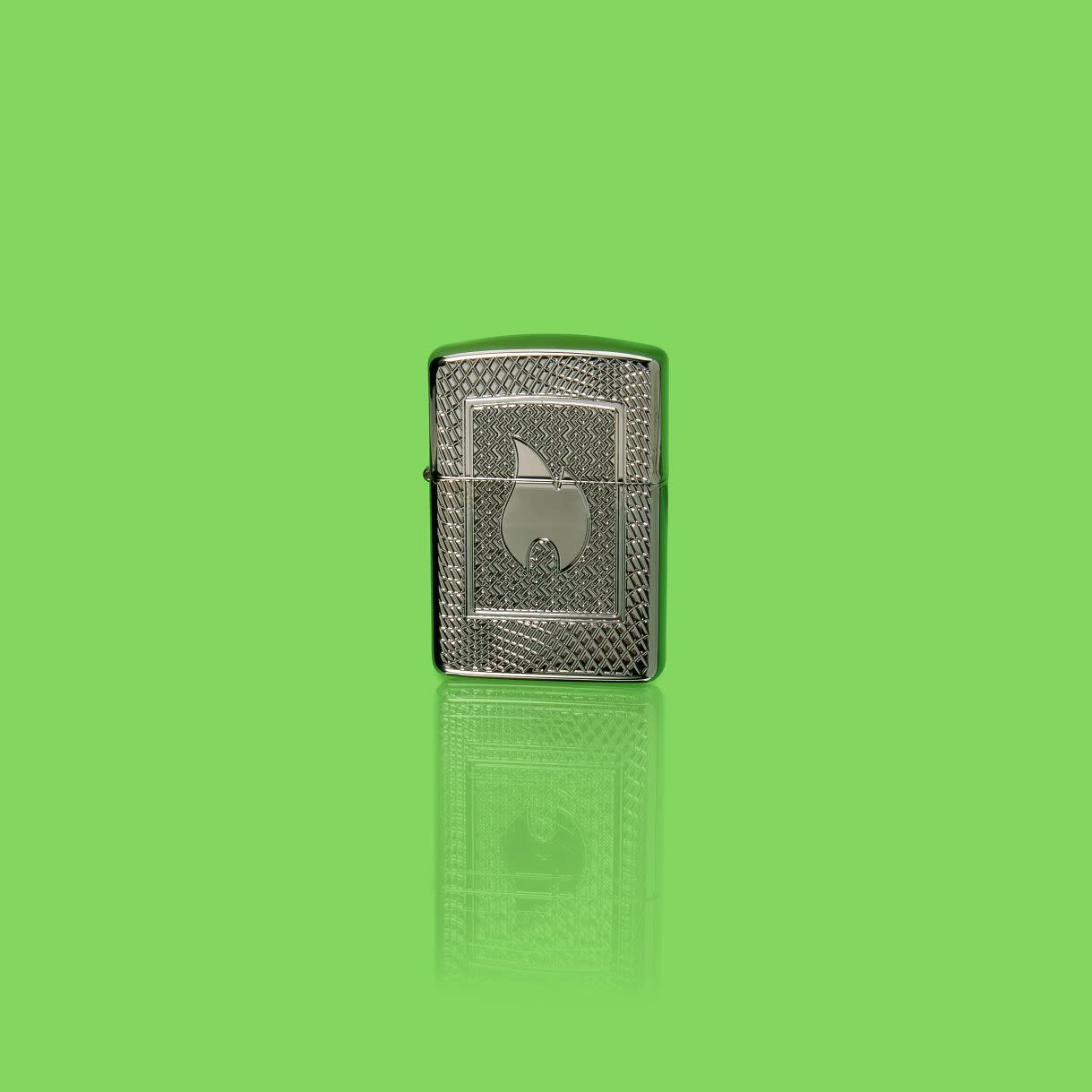 Glamour shot of Zippo Flame Pattern Design Armor Black Ice Windproof Lighter  standing in a green scene.