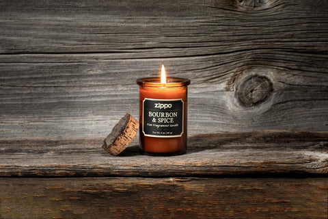 Lifestyle image of Front of Spirit Candle - Bourbon & Spice lit on a wooden stand with a wooden background
