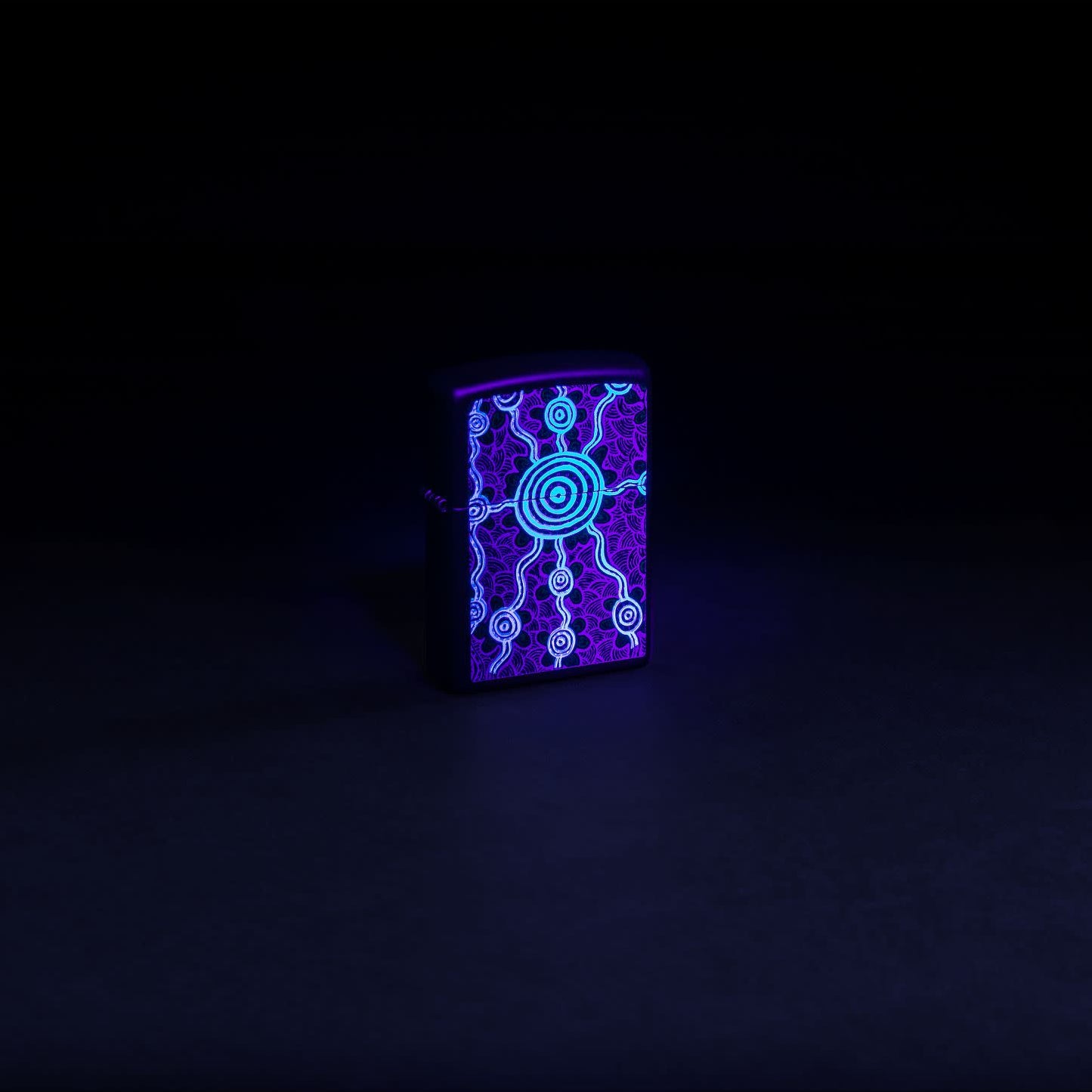 Glamour shot of Zippo John Smith Gumbula Black Light Design Black Matte Windproof Lighter glowing with a black light.