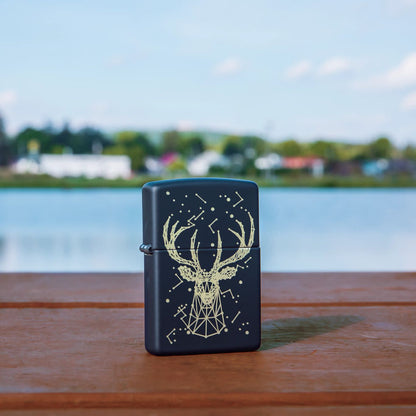 Lifestyle image of Deer Constellation Design Black Matte Windproof Lighter standing on a railing with a lake behind it.