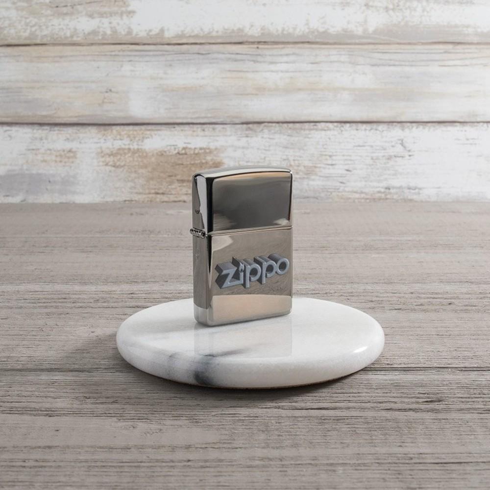 Lifestyle image of Zippo 3D Logo Design Black Ice® Windproof Lighter standing on a marble coaster.